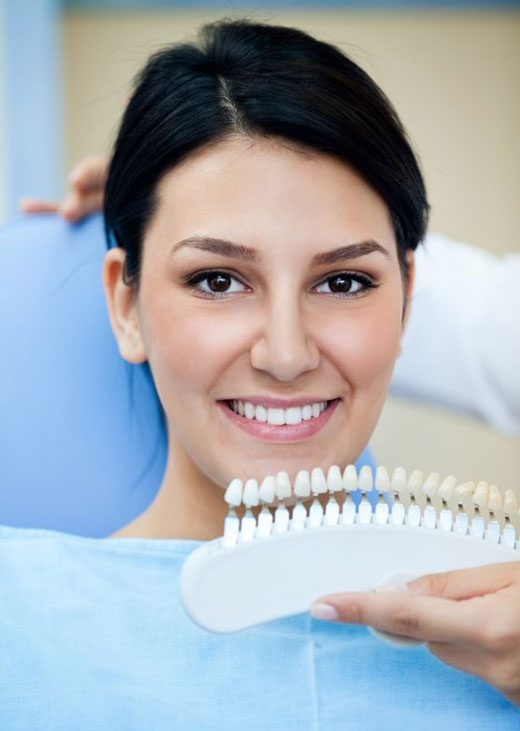 Smiling Woman With Palette For Tooth Color — Crestwood Family Dental In Molendinar, QLD